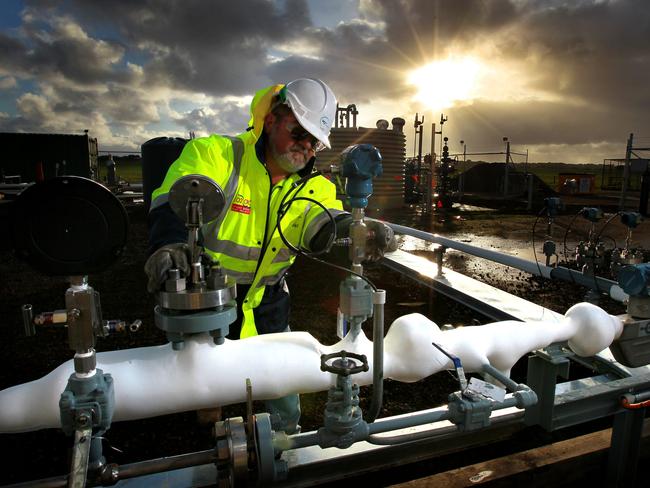 Operations Supervisor Andrew Leat working on the frozen pipes that contain the -20 degrees CO2 with the well head in the background, at the CO2CRC Otway Project CO2 Storage Research Facility near Peterborough on the West Coast of Victoria.