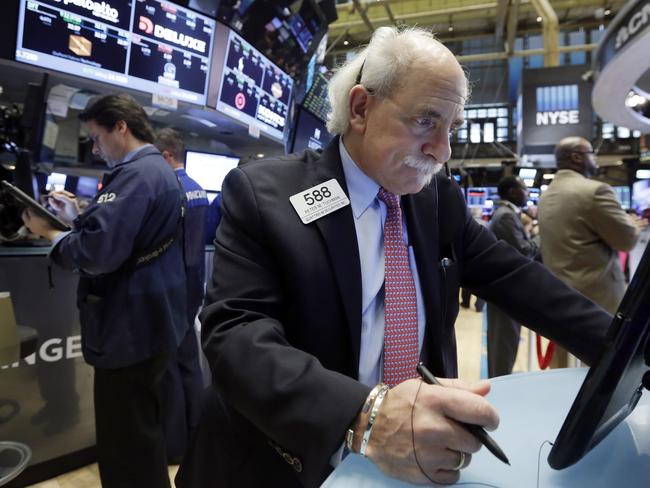 Trader Peter Tuchman, right, works on the floor of the New York Stock Exchange, Wednesday, Nov. 25, 2015. Stocks are drifting higher in early trading as markets start to wind down ahead of the Thanksgiving holiday in the U.S. (AP Photo/Richard Drew)