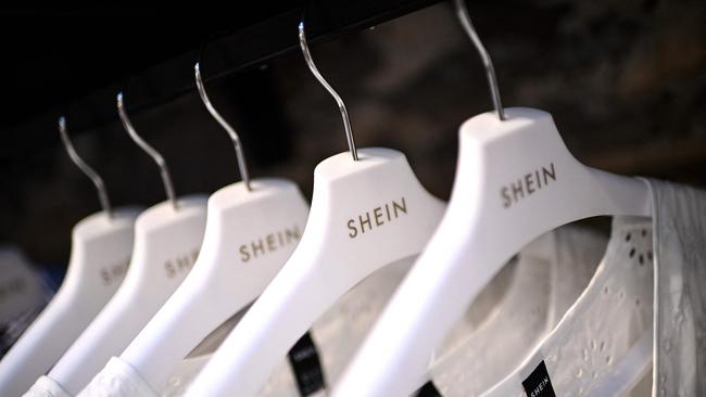 (FILES) Clothes are displayed on hangers at a Chinese fashion brand Shein pop-up store in Paris on May 4, 2023. Shein, the Chinese-founded online fast-fashion giant, could issue plans this week for a stock market listing in London, a source close to the matter told AFP on June 3, 2024. (Photo by Christophe ARCHAMBAULT / AFP)