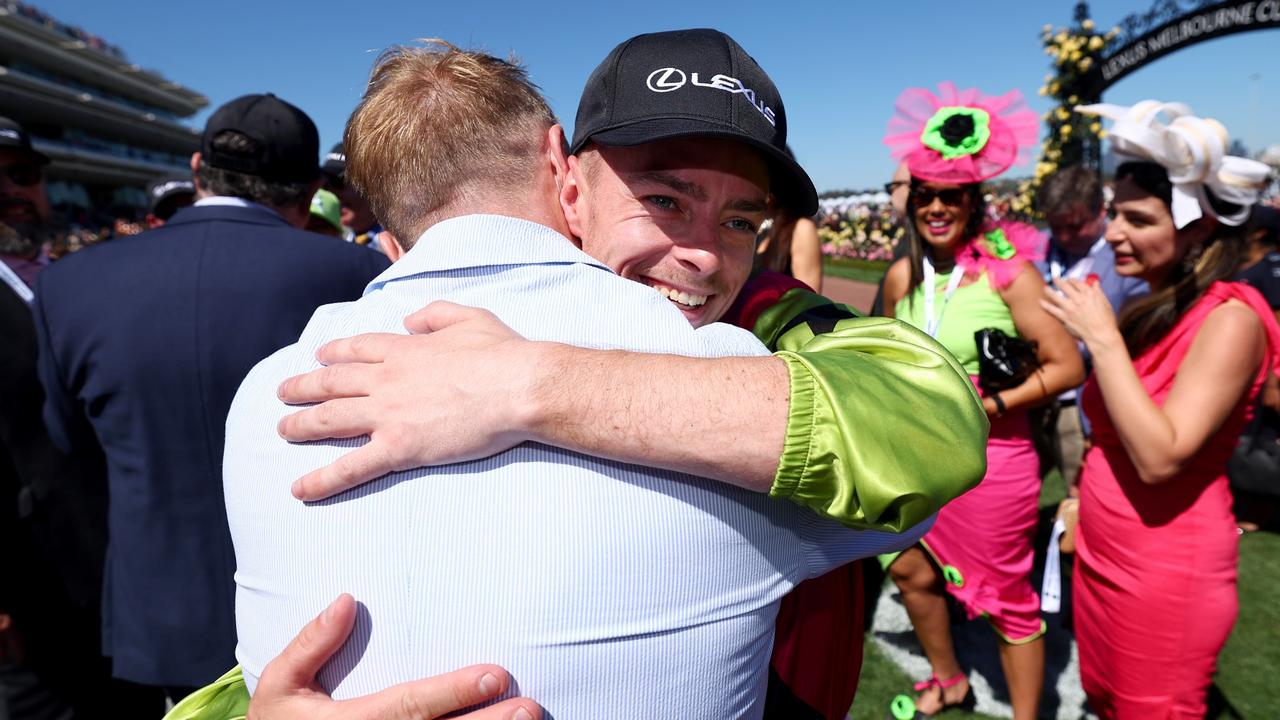 Robbie Dolan gets a hug from Ronan Keating after winning the Melbourne Cup. Picture: Josh Chadwick/Getty Images