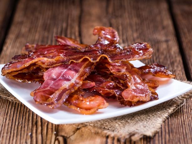 RendezView. Fried Bacon (selective focus) on an old vintage wooden table. (Pic: iStock)