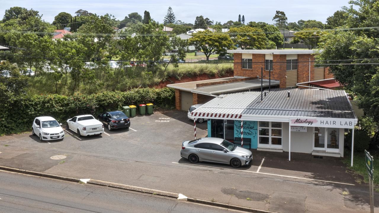 A commercial precinct featuring a barbershop and hair salon on West Street in Harristown is going up for auction through Colliers International.