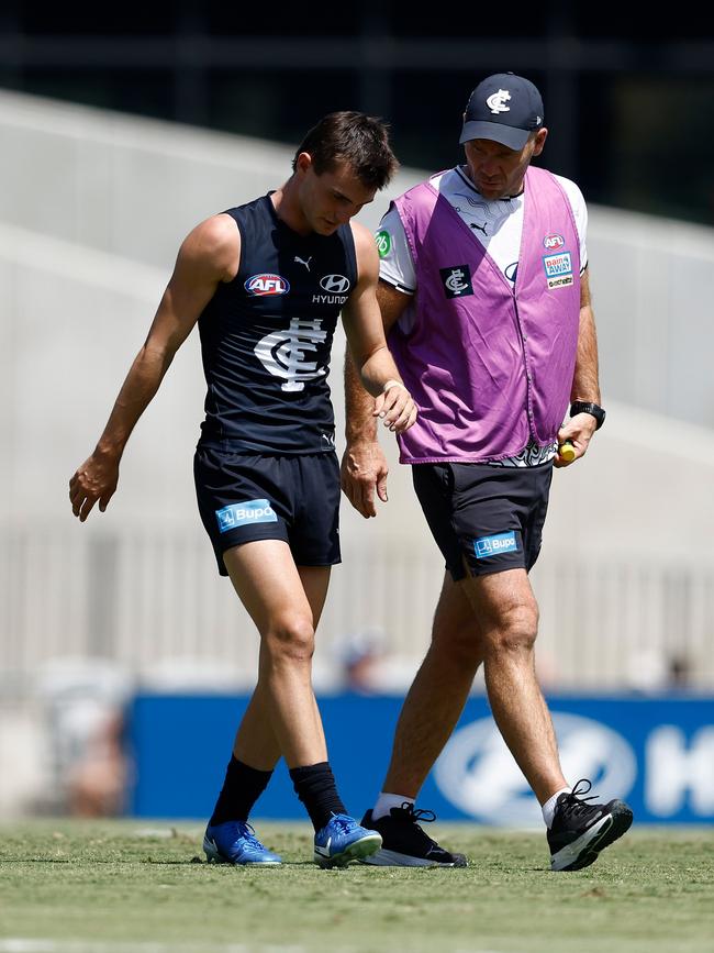 Jagga Smith is assisted off after copping a knock to the knee.