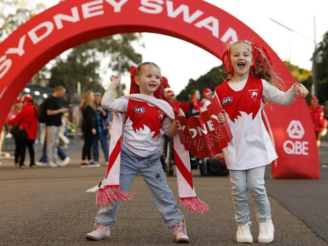 Lucia Mackenzie,4, and sister Jade Mackenzie, 6, (right) at Moore Park for the Sydney Swans vs Port Adelaide Preliminary Final. Picture: Jonathan Ng