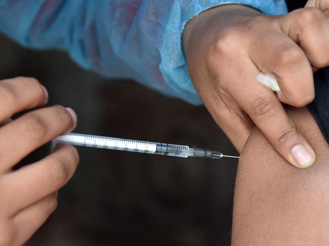 A boy is inoculated against the COVID-19 coronavirus disease at a mobile vaccination and testing medical unit in La Paz on July 19, 2022, as cases surge worldwide. - Fresh surges of Covid-19 infections around the world show the pandemic is nowhere near over, the World Health Organization's chief Tedros Adhanom Ghebreyesus lamented last week, warning that the virus is running free. The number of Covid-19 cases reported to the WHO increased 30 percent in the past two weeks, driven by sub-variants of the Omicron strain and the lifting of control measures. (Photo by Aizar RALDES / AFP)