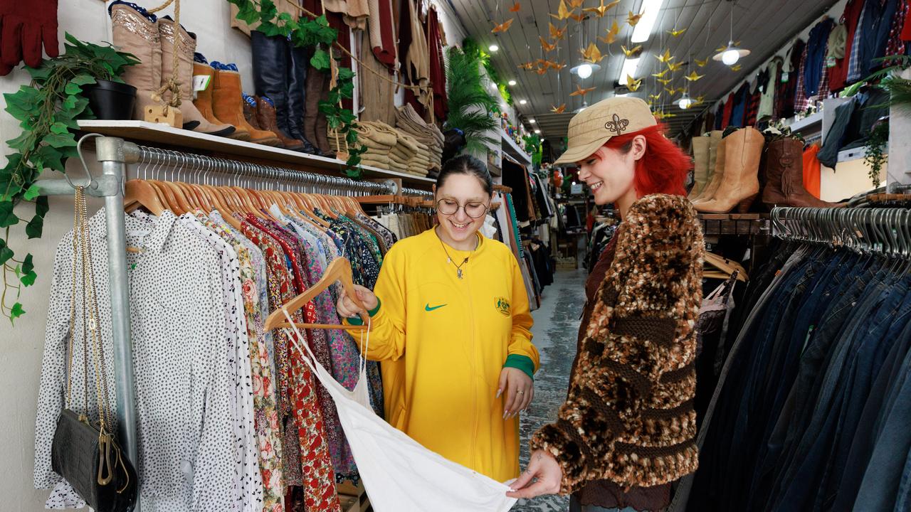 Vintage store sales assistants Sophia Kouroupakis and Mia Kandi-Franklin say second-hand is becoming a popular alternative to environmentally-damaging fast fashion. Picture: Tim Pascoe