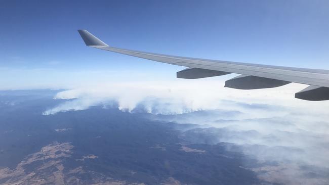 An image taken on a smart phone from a plane window, shows the smoke from the Blue Mountains bushfires. Picture: AAP