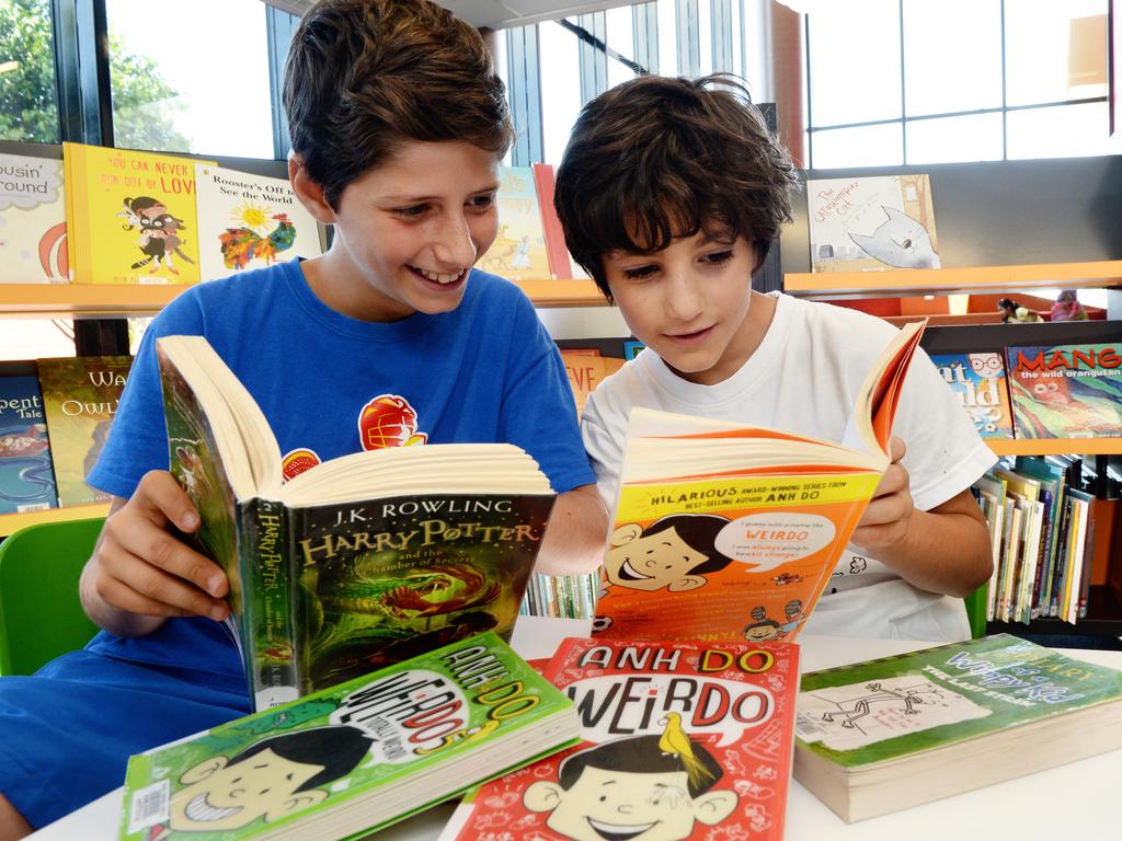 Brothers Ridvan, 12, and Yasin, 8, of Keysborough, in the Dandenong Library with Anh Do books and Harry Potter( the most borrowed kids books in Dandenong).
