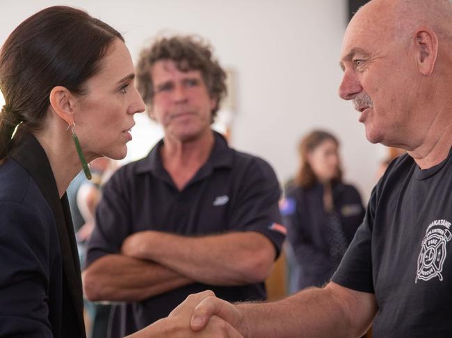 New Zealand's Prime Minister Jacinda Ardern meets with a first responder from the fire brigade that helped those injured in the White Island volcano eruption. Picture: Dom Thomas /AFP