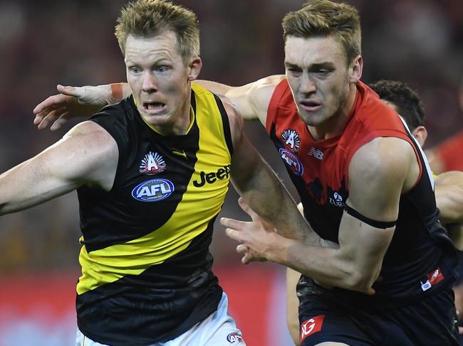 Jack Riewoldt of the Tigers (left) and Oscar McDonald of the Demons contest during the Round 5 AFL match between the Melbourne Demons and the Richmond Tigers at the MCG in Melbourne, Tuesday, April 24, 2018. (AAP Image/Julian Smith) NO ARCHIVING, EDITORIAL USE ONLY