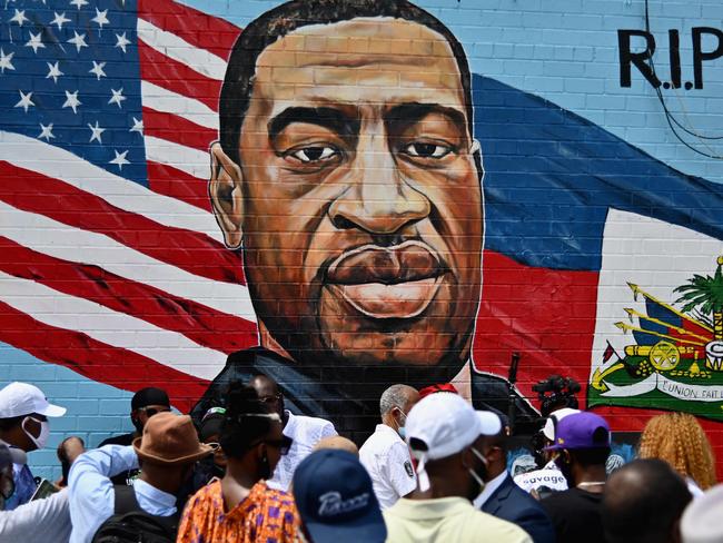 People gather at the unveiling of artist Kenny Altidor's memorial portrait of George Floyd – who died 25 May in Minneapolis with police officer Derek Chauvin kneeling on his neck. Picture: AFP