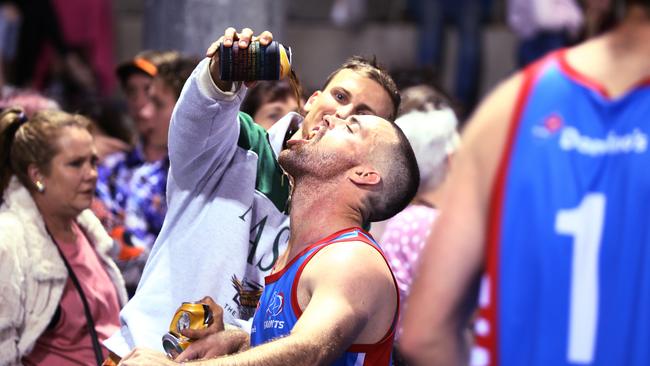 Saints’ Mitch Birt celebrates with some help from Trinity Stingers captain Apara Brewster-O’Brien after Saints won the Cairns Hockey Association A Grade Men's grand final match against Souths. PICTURE: BRENDAN RADKE