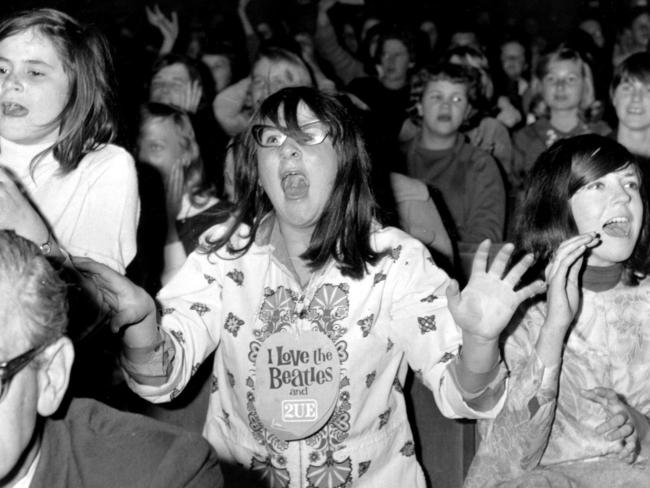 Music fans lose it when The Beatles take the stage at Sydney Stadium in 1964.