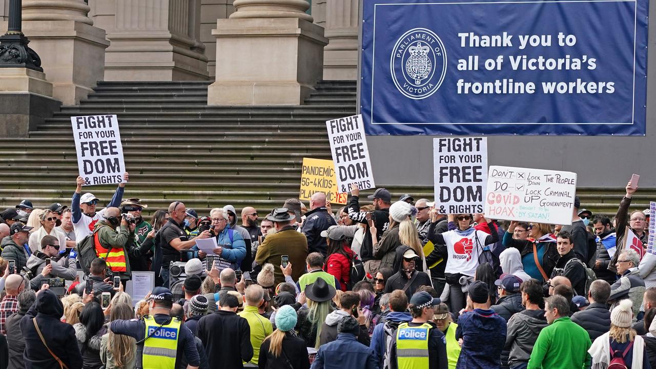 Protesters gather under a sign thanking Victorian health workers on Sunday. Picture: Scott Barbour/AAP