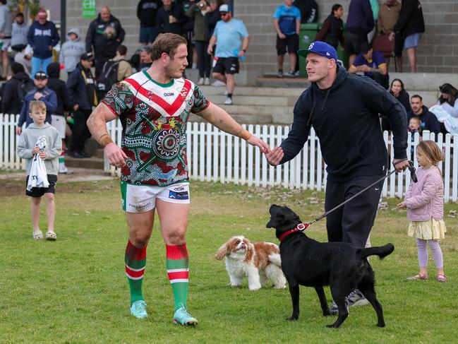 Tom Burgess shakes hands with his brother George Burgess as he runs out for the South Eastern Seagulls. Picture: Adam Wrightson Photography