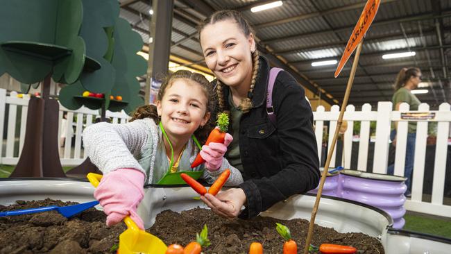 Aria Millar and mum Emily Millar unearthing carrots in the Little Backyard Farmers area at the Toowoomba Royal Show, Thursday, April 18, 2024. Picture: Kevin Farmer