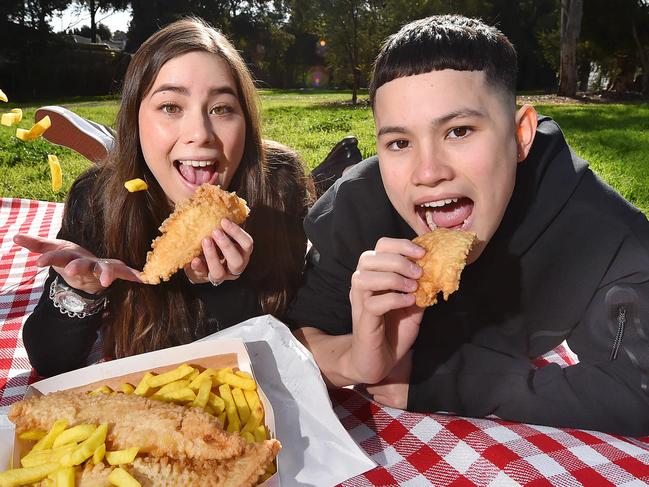 Isaac, 14 and his sister Elle, 17, eating fish and chips. Story about a new way that Melbourne doctors are trying to get kids who are allergic to fish, able to eat flake.Picture : Nicki Connolly