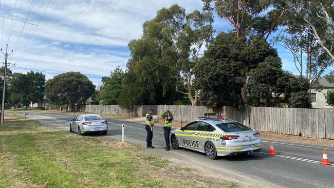 Police at Paracombe Road, which has been closed after a motorcycle collided with the rear of a bus. Picture: Patrick James