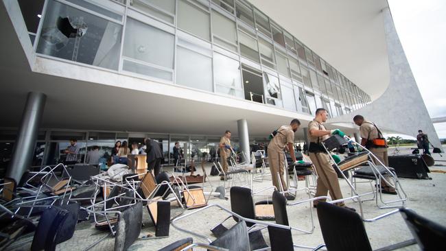 Workers clear debris caused by Sunday’s riot at Planalto Palace in Brasilia. Picture: Getty Images