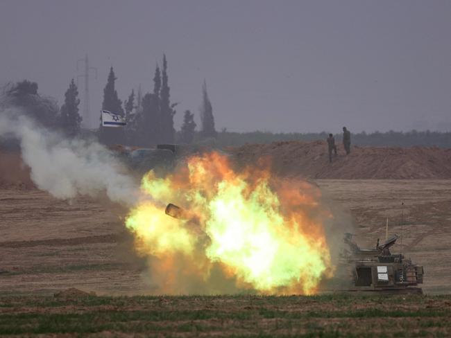 An Israeli army self-propelled artillery howitzer fires rounds from a position near the border with the Gaza Strip in southern Israel. Picture: AFP