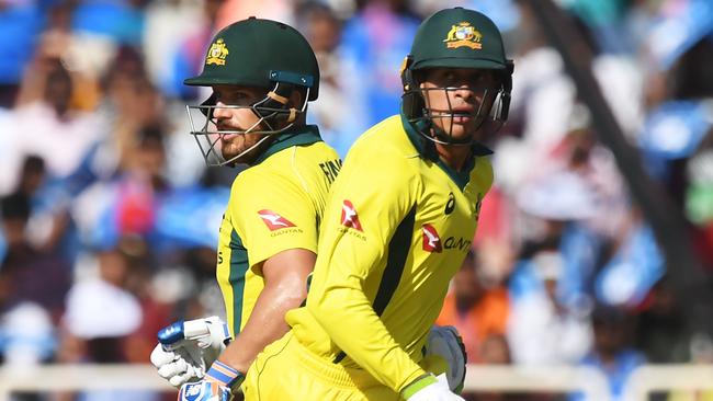 Australian cricketer Aaron Finch (L) and Usman Khawaja run between the wickets during the third one-day international (ODI) cricket match between India and Australia at the Jharkhand State Cricket Association International Cricket Stadium, in Ranchi on March 8, 2019. (Photo by DIBYANGSHU SARKAR / AFP) / ----IMAGE RESTRICTED TO EDITORIAL USE - STRICTLY NO COMMERCIAL USE-----