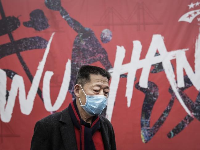 WUHAN, CHINA - JANUARY 22:  (CHINA OUT) A man wears a mask while walking in the street on January 22, 2020 in Wuhan, Hubei province, China. A new infectious coronavirus known as "2019-nCoV" was discovered in Wuhan as the number of cases rose to over 400 in mainland China. Health officials stepped up efforts to contain the spread of the pneumonia-like disease which medicals experts confirmed can be passed from human to human. The death toll has reached 17 people as the Wuhan government issued regulations today that residents must wear masks in public places. Cases have been reported in other countries including the United States, Thailand, Japan, Taiwan, and South Korea.  (Photo by Getty Images)