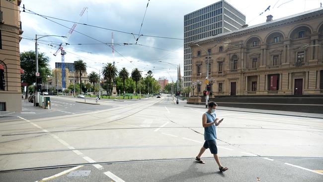 Collins Street is almost deserted on day one of a five day lockdown. Picture: Andrew Henshaw.