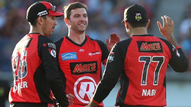 Harry Gurney of Melbourne Renegades (centre) celebrates with team mates after taking the wicket of Brendon McCullum. 