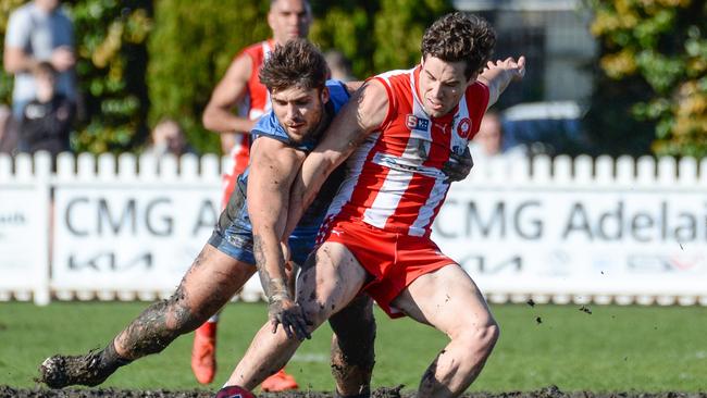 North’s Harrison Elbow muscles out Sturt’s James Battersby at Unley Oval on Saturday. Picture: Brenton Edwards