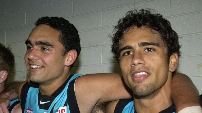 Shaun and Peter Burgoyne sing the song after they kicked 11 goals between them against the Western Bulldogs.