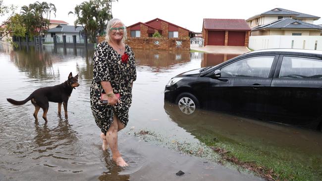 Resident Lorraine Hooker thinks positively of the floods, saying she does not have to water her garden. Picture: David Clark