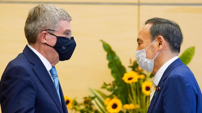 International Olympic Committee President Thomas Bach, left, speaks with Japanese Prime Minister Yoshihide Suga. Picture: AFP