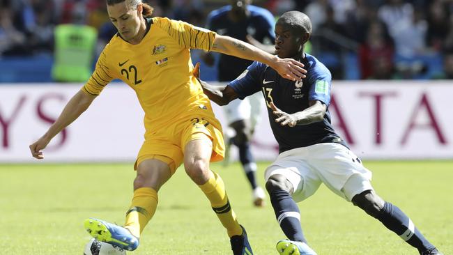 Irvine, left, and France's Ngolo Kante challenge for the ball during the Australia v France clash on June 16. Picture: David Vincent, AP