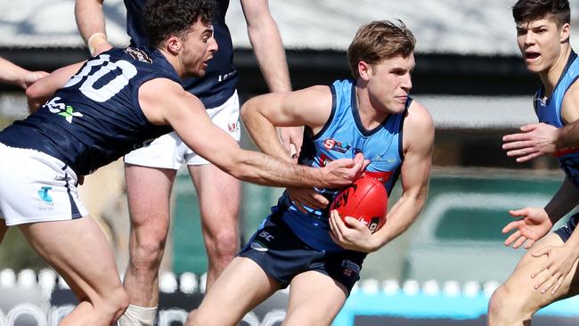 Sturt’s Sam Colquhoun bursts away from South Adelaide opponent Nic Schwarz in the Double Blues’ shock 33-point win at Unley on Saturday. Picture: Sarah Reed