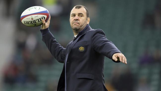 Australia coach Michael Cheika throws a ball at Twickenham in London.