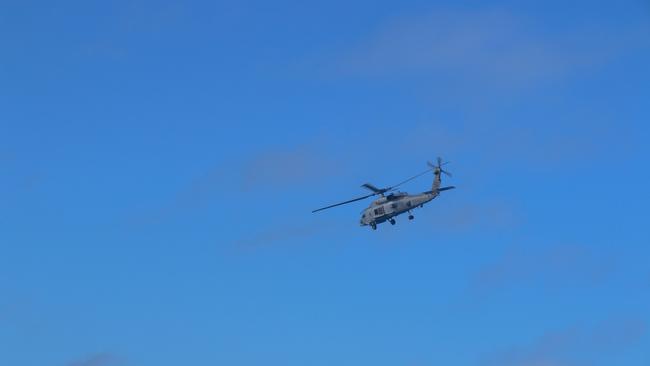 An MH-60R 'Romeo' helicopter from HMAS Brisbane conducts search and rescue operations in the vicinity of the Whitsunday’s. Picture: NCA NewsWire / Australian Defence Imagery