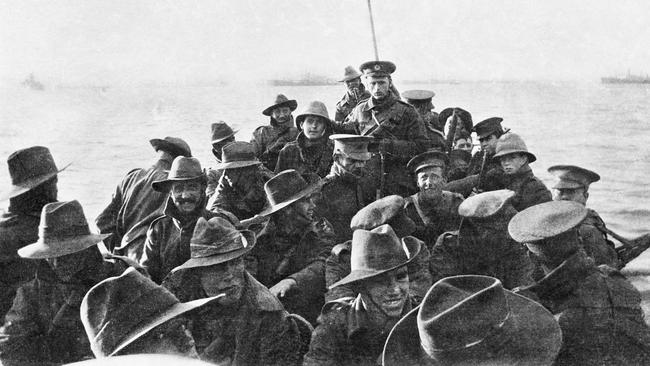 A lifeboat carrying men from the Australian 1st Divisional Signal Company is towed towards the cove at 6am on the day of the landing. Picture: Charles Edwin Woodrow Bean