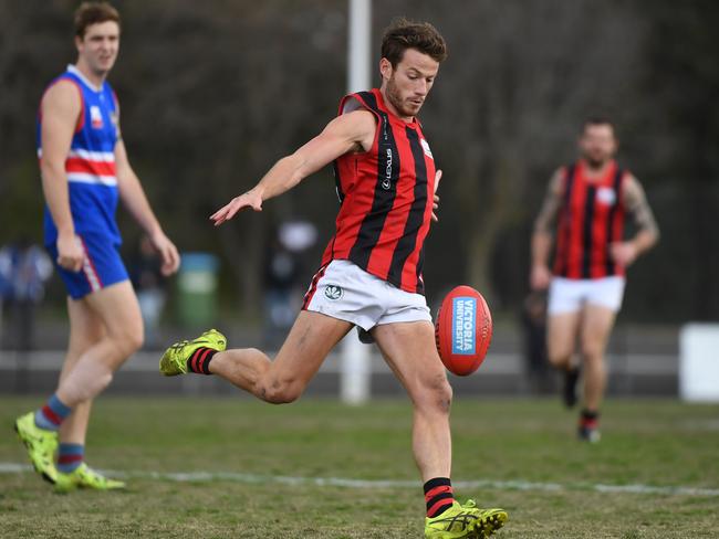 Xavier Murphy sends the ball forward. Picture: James Ross/AAP