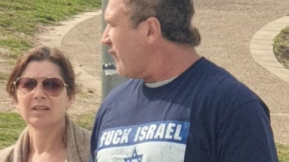 Former deputy mayor of Mosman Andrew Brown wearing a ‘F**k Isreal’ shirt.