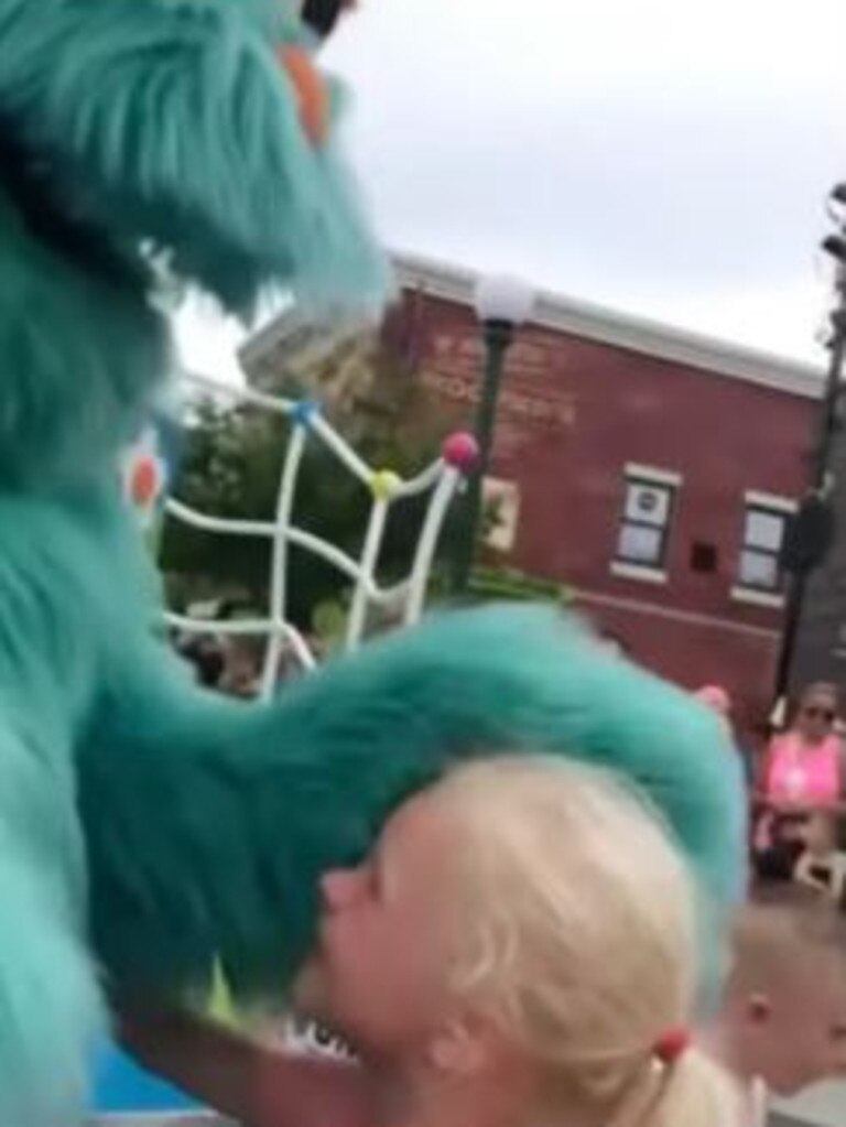 The employee in the costume instead bends down to wrap a white child in a warm embrace.