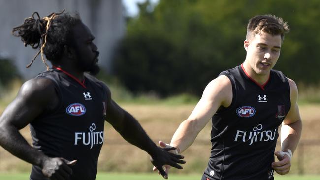 Anthony McDonald-Tipungwuti and Zach Merrett at Essendon training at the Hanger, Tullamarine. Picture: Andrew Henshaw