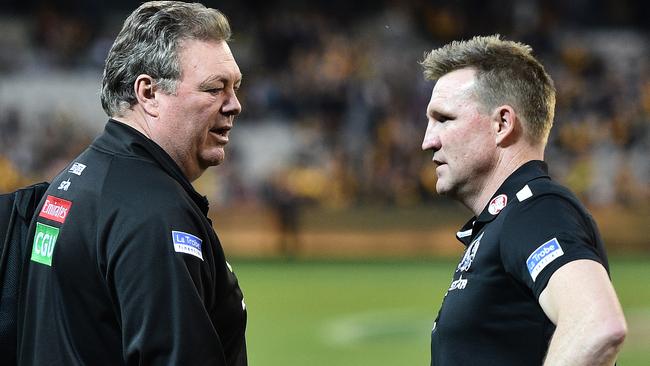 Neil Balme talks with Collingwood coach Nathan Buckley after Round 23.