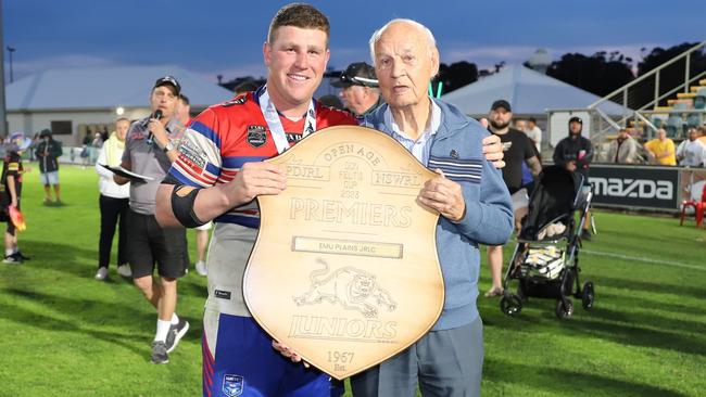 Emu Plains skipper Thomas Romer holds the Don Feltis Shield alongside Don Feltis. Picture: Steve Montgomery