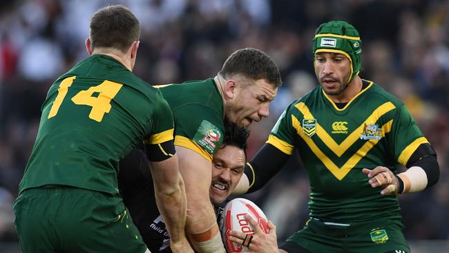 New Zealand's winger Jordan Rapana vies with Australia's Michael Morgan and Johnathan Thurston.