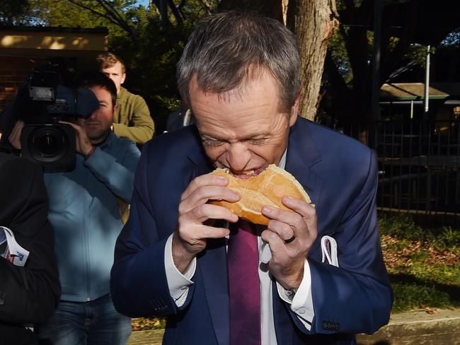 Leader of the Opposition Bill Shorten eats a sausage sandwich at Strathfield North Public School polling booth as part of the 2016 Election Day in Sydney, Saturday, July 2, 2016. Picture: AAP Image/Mick Tsikas