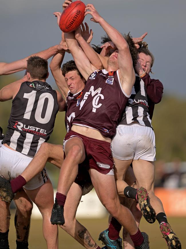 Melton and Darley players fly for the mark. Picture: Andy Brownbill