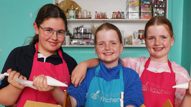 Young gingerbread house designers Anna Moorfoot and Hannah and Jessie Keller. Suzie from the Kidz Kitchen is hosting school holiday activities in January. She is hosting pre Xmas after school classes too. Picture: Alan Barber