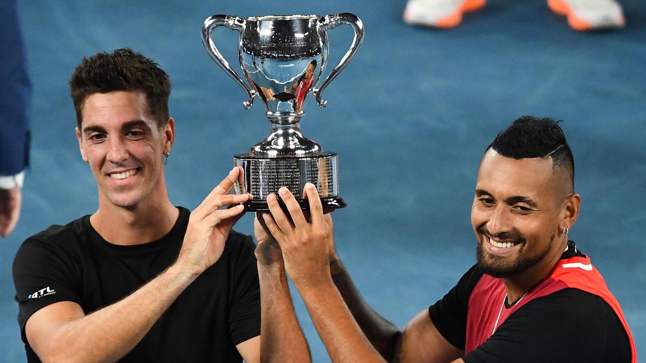 Australia's Thanasi Kokkinakis and Nick Kyrgios pose with the trophy after winning against Australia's Matthew Ebden and Australia's Max Purcell in the men's doubles final at the 2022 Australian Open.. Photo by William WEST / AFP.