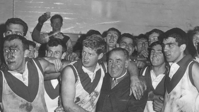 Skilton (left, with cut forehead) celebrates a 1965 victory over Carlton.