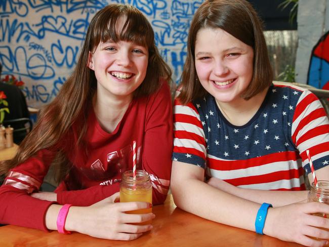 Amelie Jones, 12 and Charlotte Jones, 14, enjoying a juice at Devon Cafe, in Surry Hills, today. (See story on kids using wearable devices to pay at the checkout).Picture: Justin Lloyd.